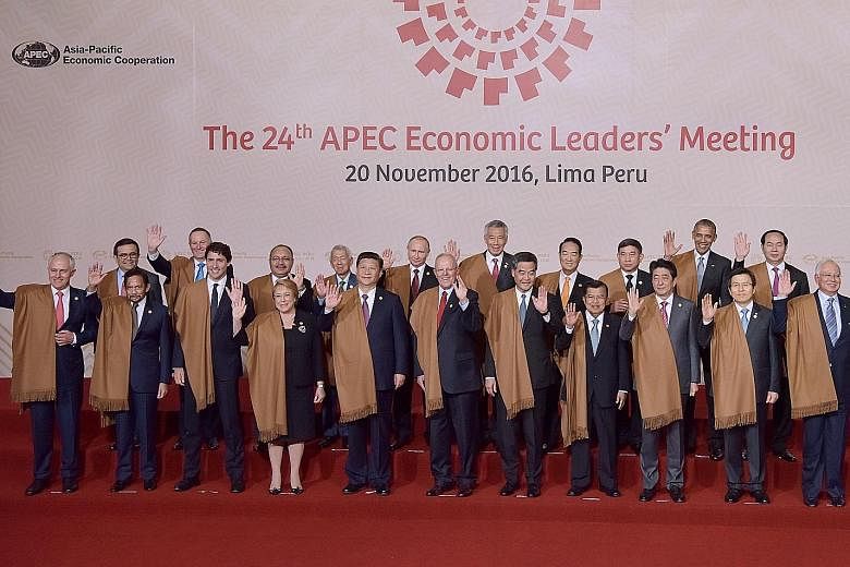 Apec leaders posing for a family photo in Lima on Sunday. They are (front row, from left) Australia's Prime Minister Malcolm Turnbull, Brunei's Sultan Hassanal Bolkiah, Canada's Prime Minister Justin Trudeau, Chile's President Michelle Bachelet, Chin