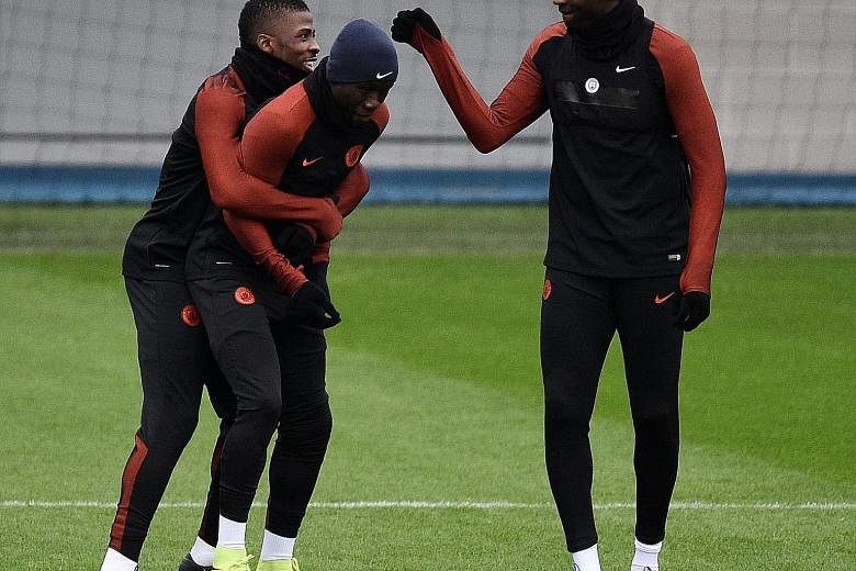 Manchester City's Yaya Toure (right) and Kelechi Iheanacho (left) playing a joke on Bacary Sagna during training yesterday. The return from a three-month exile of Toure, who scored both goals in Saturday's 2-1 Premier League victory at Crystal Palace