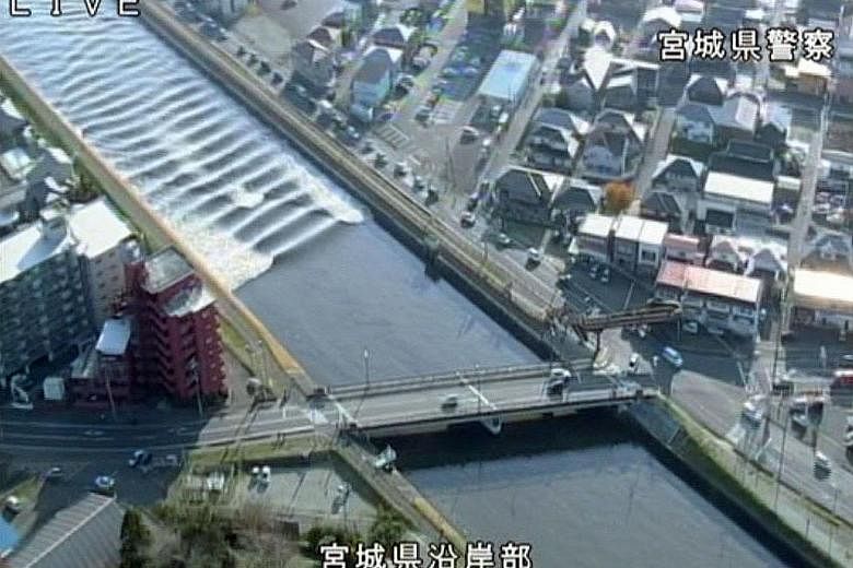 A tidal surge seen in the Sunaoshi River yesterday in this video grab image released by Miyagi Prefectural Police via Kyodo. Tsunami advisories were issued after the earthquake in Tagajo, Miyagi prefecture.