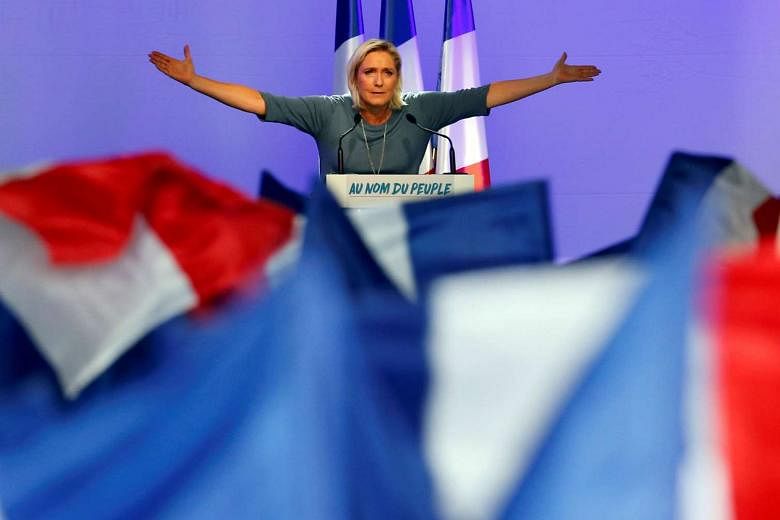 French National Front leader Ms Le Pen during a rally on Sept 18. A Le Pen presidency could lead to the collapse of the EU. She wants to pull France out of the euro and to hold a referendum on France's EU membership. 
