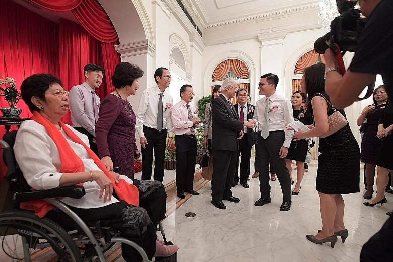 President Tan and Mrs Tan (in purple dress) with guests at the President's Challenge 2016 Appreciation Night at the Istana, held to thank sponsors, donors and volunteers for their contributions.