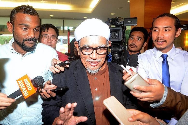 The hudud Bill was proposed by Parti Islam SeMalaysia president Abdul Hadi Awang (above, wearing spectacles).