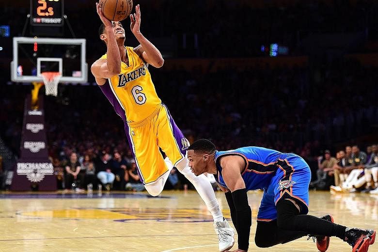 Jordan Clarkson of the Los Angeles Lakers scoring on his off-balance shot as he is fouled by the Oklahoma City Thunder's Russell Westbrook during a National Basketball Association game. The Lakers won 111-109 in the dying seconds to snap a nine-game 