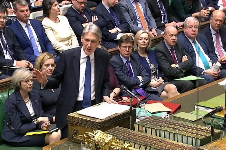 Britain will cut its corporate tax rate to 17 per cent, Mr Hammond said in the government's first Budget statement since the Brexit vote. He also raised Britain's minimum wage level and hiked tax thresholds.