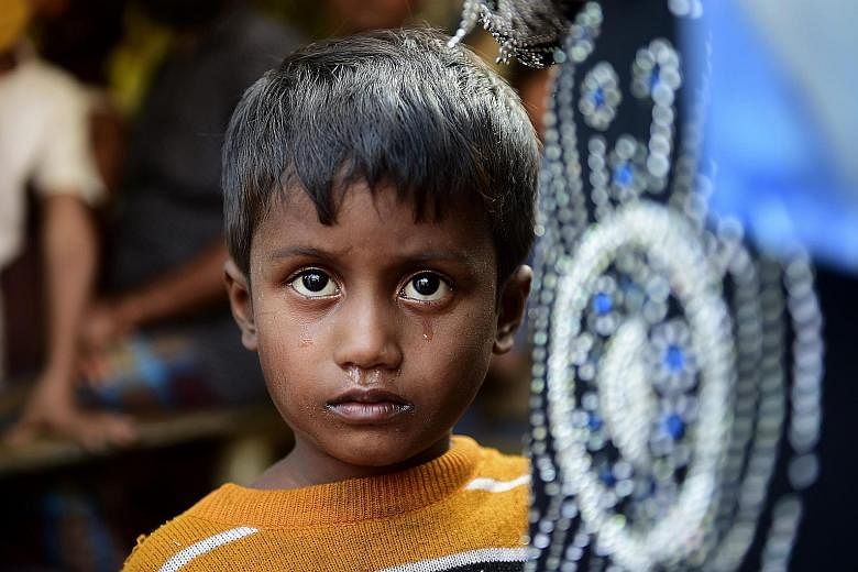 Noor Sahara, six, near a refugee camp in Teknaf, in Bangladesh, yesterday. Her mother is missing and she crossed over the border with her neighbour Roshida. A surge in violence in Myanmar has forced many Rohingya to seek refuge in neighbouring Bangla