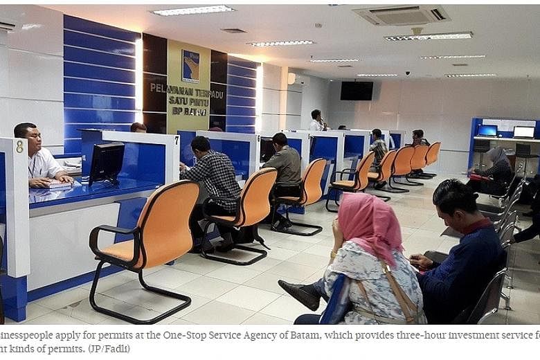 Business people apply for permits at the one-stop service agency of Batam. Business licence approvals for companies will now take only three hours, when previously they could take weeks to months.