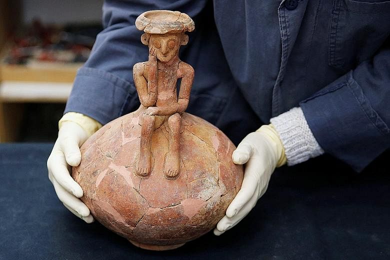 The pottery jug with statuette dates back to the Middle Bronze Age and is believed to be part of a collection of funeral offerings. It was discovered during an excavation in a Tel Aviv suburb.