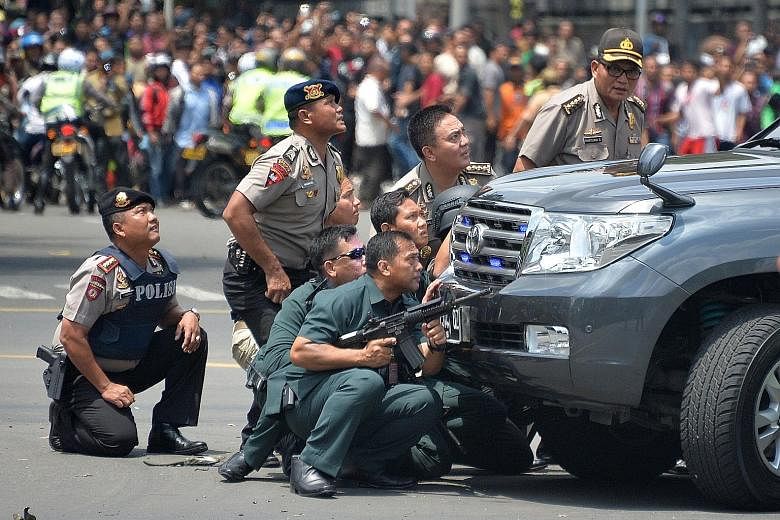 Indonesian police in Jakarta taking position behind a vehicle in pursuit of suspects during the Jan 14 terror attack, in which eight people, including the four perpetrators, died. The Islamic State in Iraq and Syria later claimed responsibility for t