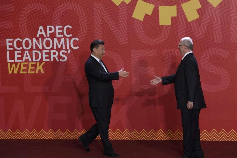 Chinese President Xi (left) meeting his Peruvian counterpart, Mr Pedro Pablo Kuczynski, at the Apec Summit in Lima last week. In view of President-elect Trump's vow to pull the US out of the TPP, Mr Xi has wasted no time in presenting his country as a rel