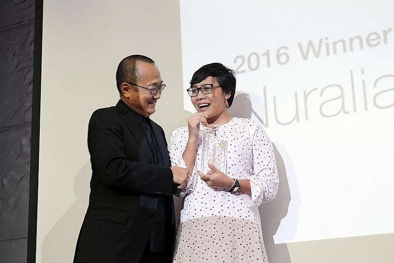 Epigram's founder Edmund Wee congratulating Nuraliah on her win.