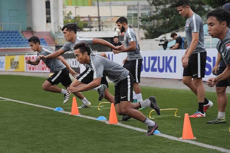 (From left) Attackers Shahdan Sulaiman, Khairul Amri and Faris Ramli sprinting during a training session yesterday. National caretaker coach V. Sundramoorthy denied reports of unrest in the team.