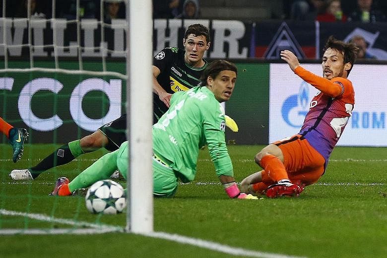 Manchester City's David Silva (right) scoring the equaliser in the 1-1 Group C match at Borussia Monchengladbach on Wednesday as goalkeeper Yann Sommer (centre) and Andreas Christensen look on. The drawn game was sufficient to put City into the Champ