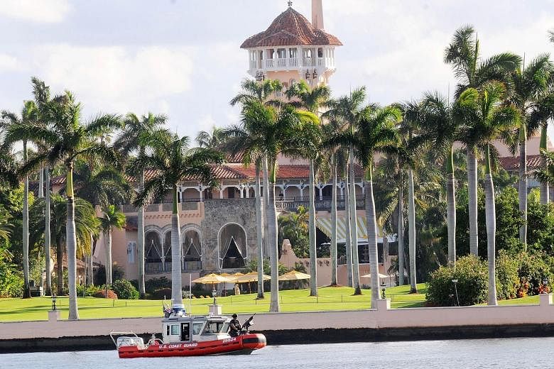 A US Coast Guard boat passing the Mar-a-Lago Resort in Palm Beach where Mr Trump spent Thanksgiving on Wednesday. The President-elect plans to further relax funding rules for the inauguration festivities.