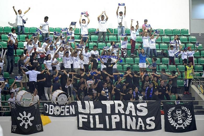 Above: A section of the Filipino die-hard football fans enjoying themselves at the 2-2 draw against Indonesia on Tuesday night at the Philippine Sports Stadium in Bocaue. Left: The stadium (right) in the province of Bulacan, about 35km north of Metro