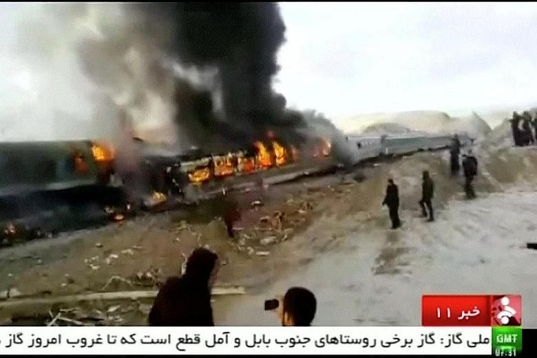 The burning wreck of the train crash. The economic sanctions imposed upon Iran due to its nuclear programme made it difficult to modernise the country's rail infrastructure, impacting safety standards.