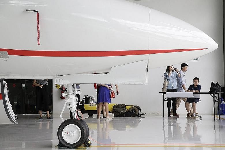 Nine-year-old Huo Xi Cheng sketching a picture of the Hawker 700 business jet which he got to see up close at Temasek Polytechnic's Aviation Academy on Friday.
