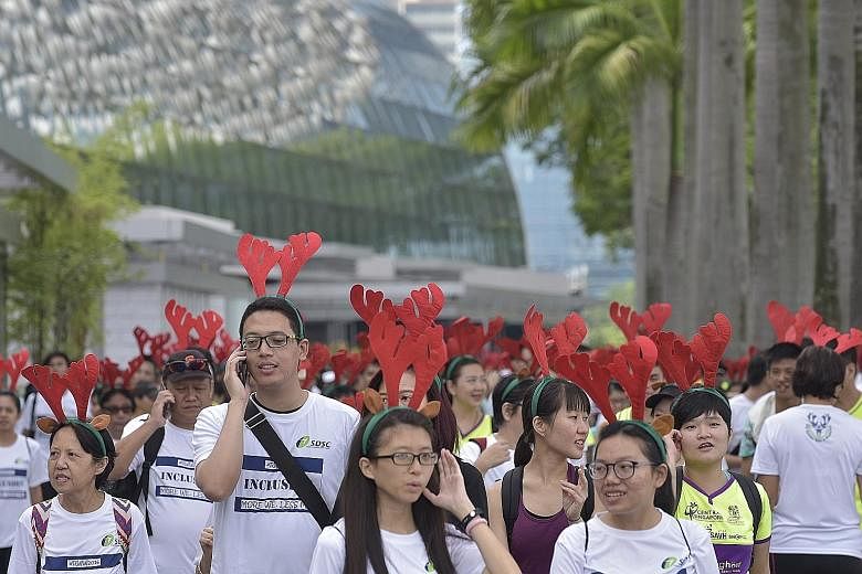 More than 1,000 people donned reindeer-ear headbands and took part in a 3km mass walk in the Marina Bay area yesterday. The Reindeer Walk-a-Wheelathon, now in its third edition, is an annual event to help raise funds to support para-athletes. It is o