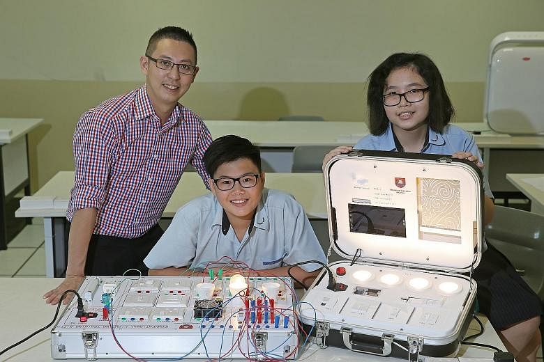 Chong Boon Secondary students Lim Yung Shan (centre) and Ea Xin Jie, both 14, will be taking the applied subject, smart electrical technology, next year. It will be taught by teacher Larry Lim, 38, who said: "Smart home systems are gaining popularity