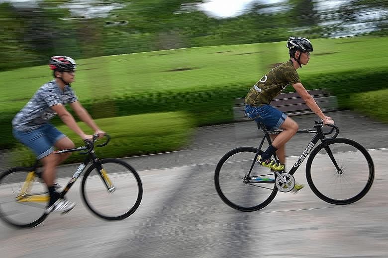 Students Sim Jia Fu (at right) and Jason A. Dennis have been gearing up for their first HolyCrit race by cycling almost every week from Woodlands to Marina Bay.