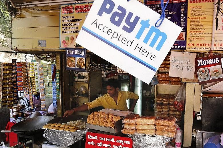 A street food vendor in New Delhi with a sign indicating that mobile phone payment is accepted. Credit Suisse estimates that more than 90 per cent of consumer purchases in India are transacted in cash.