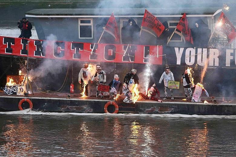 Agent Provocateur founder Joe Corre set fire to what he said was $8.9 million of punk memorabilia as well as human effigies (above) to protest against Punk London, while his mother, fashion designer Vivienne Westwood, called for the crowd to support green