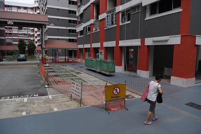 The area around the HDB block (left) in Hougang was cordoned off after a piece of the facade (above), measuring 1.2m by 0.6m, fell from the top on Sunday. The town council has engaged an engineer to carry out detailed investigations.