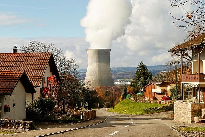 Steam emerging from a cooling tower of Leibstadt, one of five nuclear power plants in Switzerland. If the initiative had been passed, this reactor would have been the last to be shuttered in 2029.