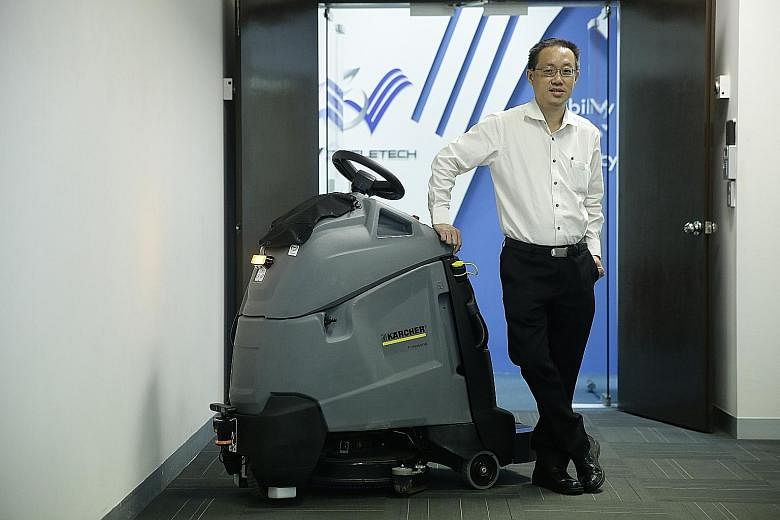 Mr Long with an autonomous maintenance machine. He says the key component of the V3Transformer technology is the intelligent robotic brain, which his company can retrofit onto any existing mechanical sweeper or scrubber in the cleaning industry.