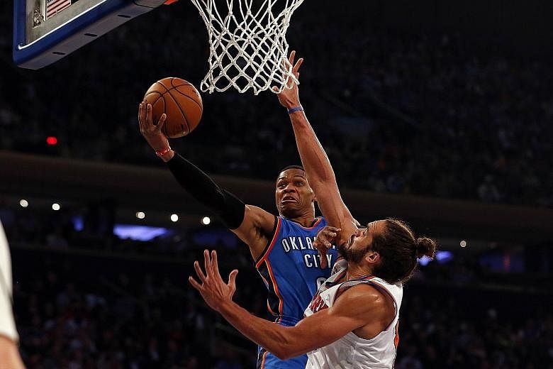 Thunder guard Russell Westbrook drives to the basket past Knicks centre Joakim Noah at Madison Square Garden. Westbrook finished with 27 points, 18 rebounds and 14 assists.