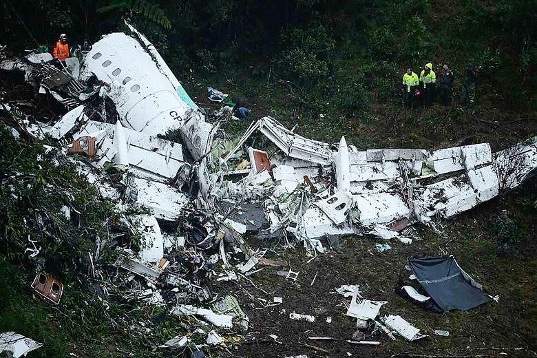 The wreckage of the Lamia plane that carried the Chapecoense Real football team in the mountains of Colombia yesterday. Brazil's President Michel Temer has declared three days of mourning for the victims. A survivor, Brazilian journalist Rafael Henze