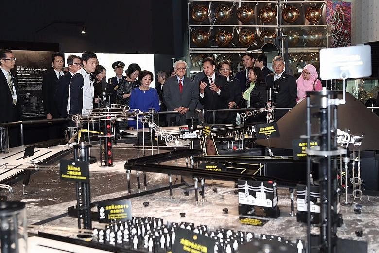 President Tony Tan and his wife Mary viewing Mission Survival: 10 Billion, a physical representation of the hazards facing the planet, including natural and man-made disasters, at Tokyo's National Museum of Emerging Science and Innovation.