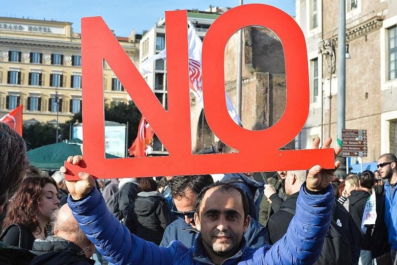 A demonstrator in central Rome last Sunday urging fellow Italians to reject constitutional reforms. For many ordinary Italians, the real problem is economic stagnation.