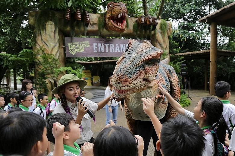 In A Very Electric Christmas, actors wearing glow-in-the-dark wires on their clothes act out a play about a bird which has lost its way. Dinosaurs come back to life at the Singapore Zoo (see D4 for story).