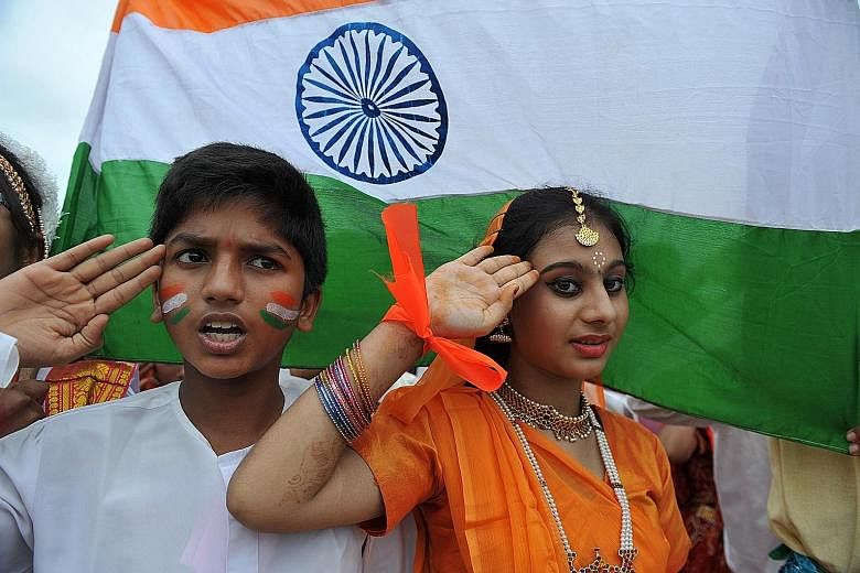 Schoolchildren singing India's national anthem in Hyderabad. The Supreme Court has ordered that the anthem be played before every movie screening in cinema halls, and everyone must stand for the duration.