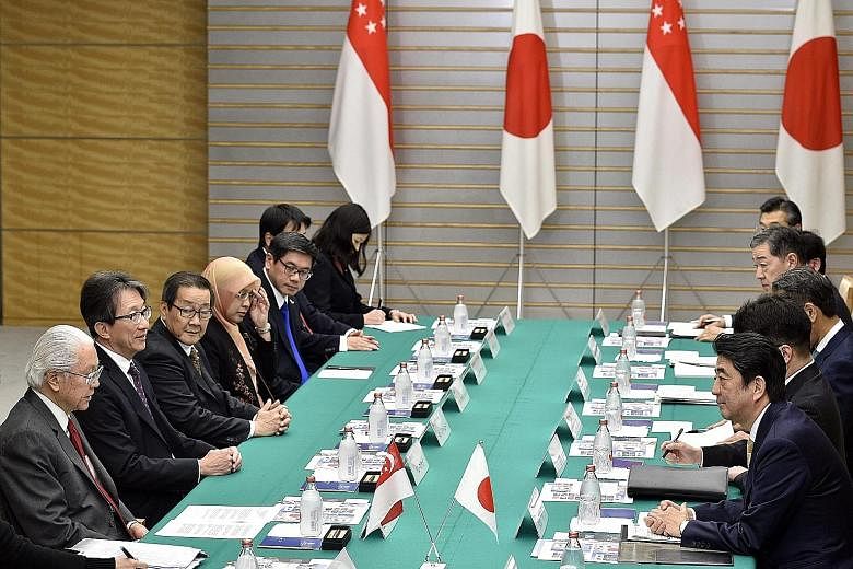 President Tan (front left) and Prime Minister Abe (front right) speak up against protectionism during their meeting at Mr Abe's official residence in Tokyo,