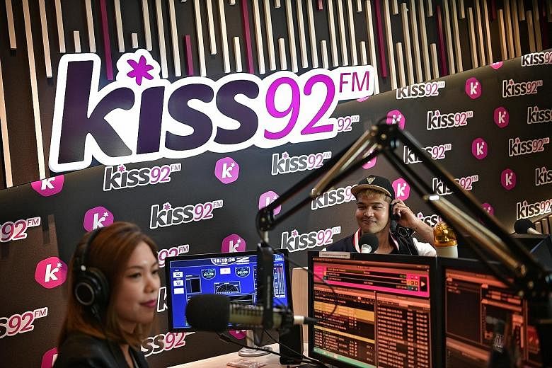 Kiss92 DJs Desiree Lai and Joshua Simon in the studio yesterday. The station's cumulative listenership went up by 6.2 per cent in the latest Nielsen Radio Diary Survey. UFM100.3 had a 17.4 per cent increase in listenership.