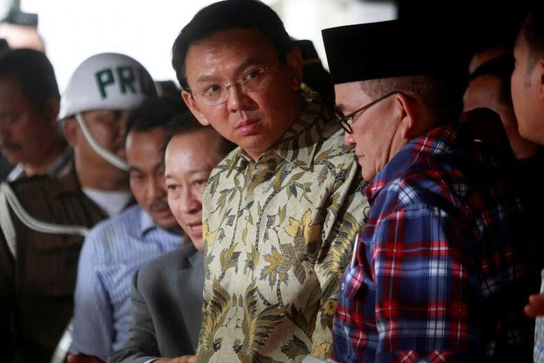 In Indonesia's ideological war, Jakarta Governor Basuki, seen here leaving the A-G's office in Jakarta yesterday, represents the reformists together with President Joko. They are pitted against entrenched interests in the form of former president Yudhoyon