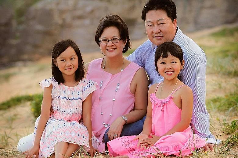 Mr Sing and his wife with their children Hailey (far left) and Emily.