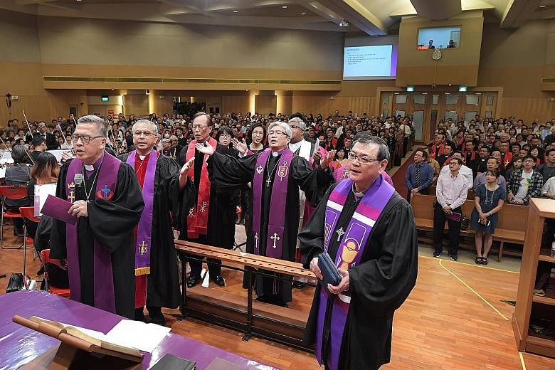 With Dr Chong (with arms outstretched) at his consecration service yesterday were (from left) Bishop Emeritus Dr Wee; Dr James Kwang, bishop of the Chinese Methodist Church in Australia; Bishop Chen Chien Chung of the Methodist Church in Taiwan; and 
