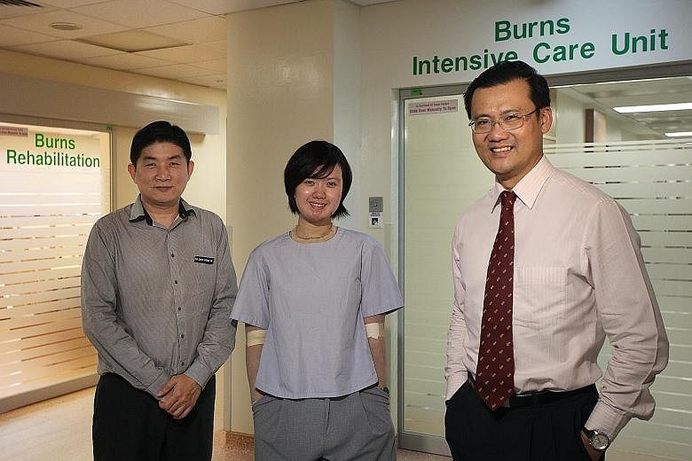 Ms Loy, with Dr Chew Khong Yik (left) and Associate Professor Tan Bien Keem, who were with her every day as she spent four months in hospital, enduring great pain during treatment. Prof Tan said the team was surprised by her positive attitude.