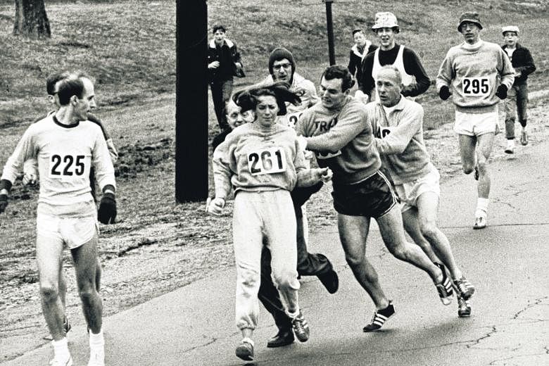Kathrine Switzer (261) of Syracuse, New York, was spotted early in the 1967 Boston Marathon by race official Jock Semple (behind her in trousers), who tried to rip the number off her shirt and remove her from the race. The then 20-year-old's friends 