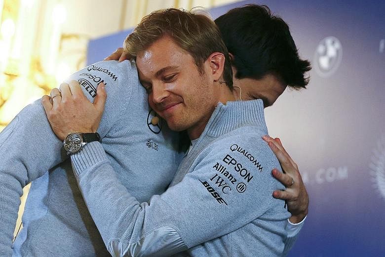 Mercedes' world champion Nico Rosberg hugging the Formula One team's executive director Toto Wolff during a news conference in Vienna yesterday after announcing his retirement.
