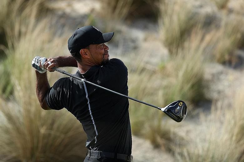 Tiger Woods hitting his tee shot on the third hole in round one of the Hero World Challenge. He showed glimpses of his old self, sharing the lead after eight holes.