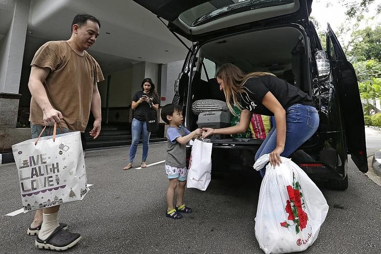 In the spirit of Christmas, several black cars from ride-hailing service company Uber - UberSLEIGHs - turned up at people's homes and offices yesterday to collect toys, books, clothes and stationery. Singapore Red Cross will distribute the items to u