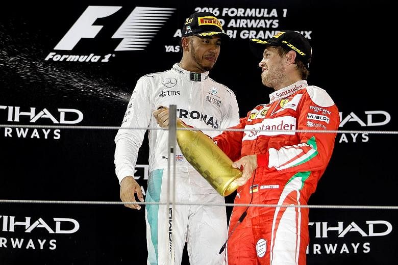 Lewis Hamilton and third-placed Sebastian Vettel celebrating on the podium after the Abu Dhabi Grand Prix on Nov 27. The two drivers have seven world titles between them.