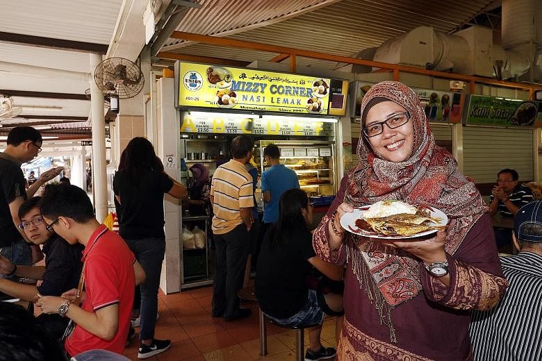 Mizzy's Corner owner Mizrea Abu Nazir with ikan kuning nasi lemak at her stall. By February, Indian mackerel will be used instead.