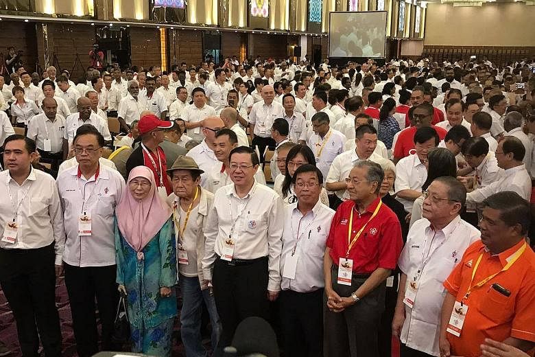 Dr Mahathir (third from right), with veteran DAP leader Lim Kit Siang (second from right), PKR leader Wan Azizah Ismail (second from left) and other opposition leaders at the convention on Sunday.