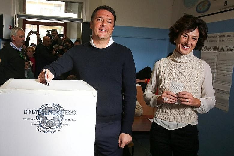 PM Renzi, seen here with his wife Agnese, casting his vote for constitutional reform. He has vowed to step down if his proposals to streamline Italy's 68-year-old parliamentary system were voted down.