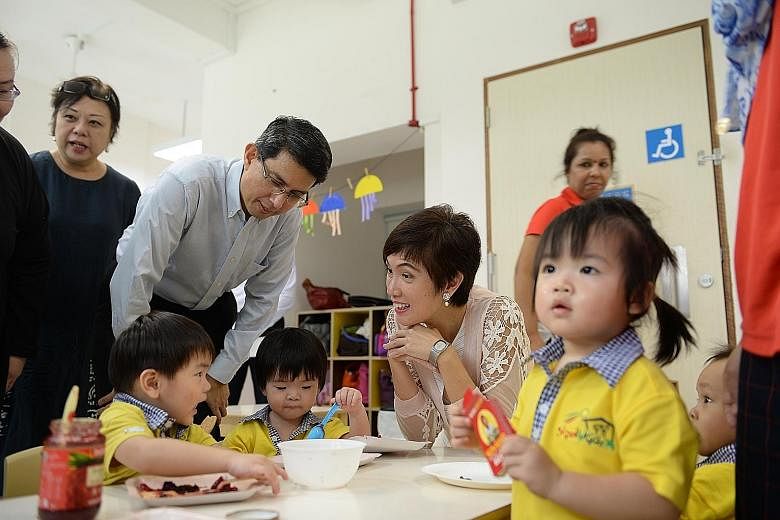 Mrs Teo and Dr Faishal interacting with children during a visit to the Skool4kidz childcare centre yesterday. Mrs Teo sees the growing number of infants enrolled in childcare centres as a reason for action, saying: "If we want to provide better suppo