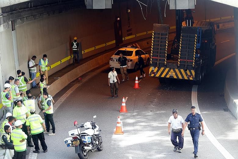 The lorry was on the slip road to the Central Expressway in Upper Cross Street yesterday when its crane struck the roof of the tunnel at around 1pm. The tunnel was reopened only around 6pm. Police said the 63-year-old driver was arrested.